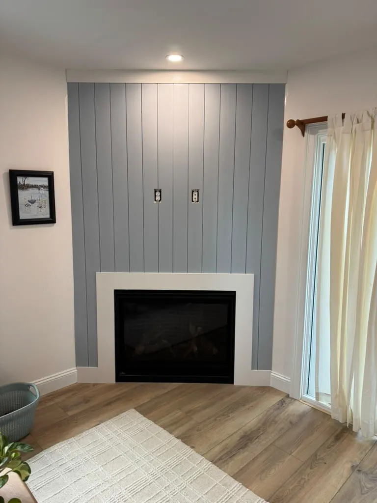 Gray shiplap fireplace wall with white surround