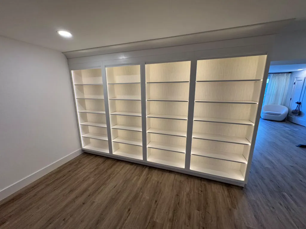 Floor-to-ceiling built-in bookcases with lighting